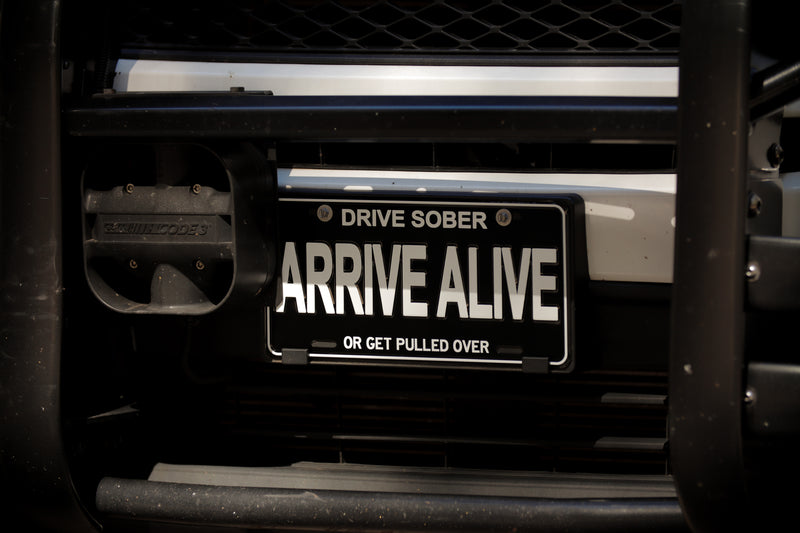 Load image into Gallery viewer, &quot;ARRIVE ALIVE&quot; Embossed License Plate
